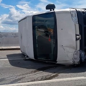 Motorista perde controle da direção e capota van em  ponte