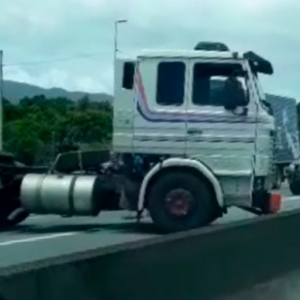 Caminhão roda na pista e colide contra mureta de proteção da BR-101